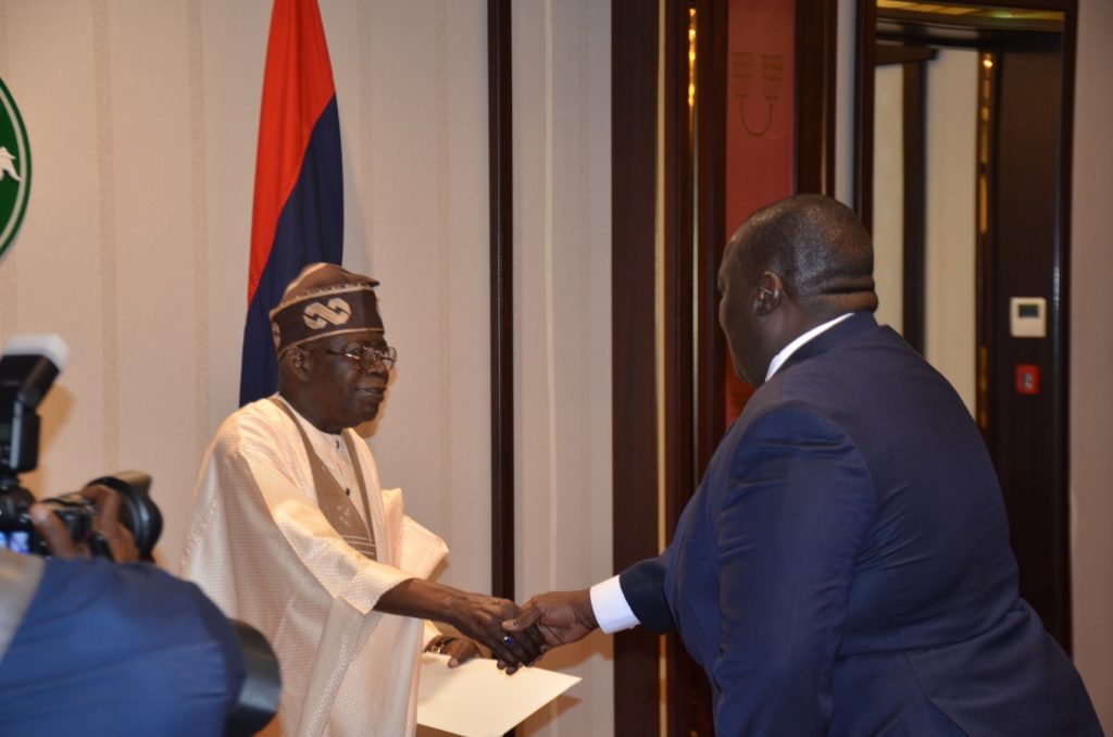 The High Commissioner exchanges a handshake with President Bola Ahmed Tinubu of Nigeria.